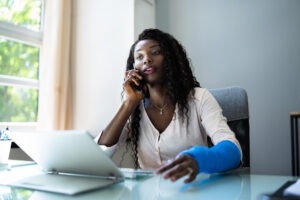 black woman in a cast calling for help