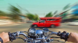 motorcycle racing toward a red truck