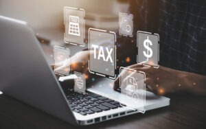 businessman using computer with tax graphics