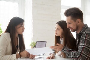 couple going over benefits with workers’ comp agent