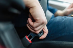 man latching seat belt