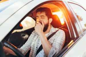 man-yawning-behind-the-wheel