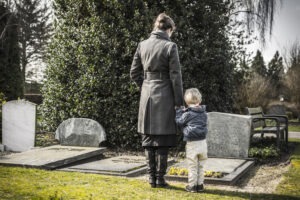 mom and child visiting grave