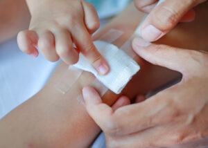 child applying a bandage