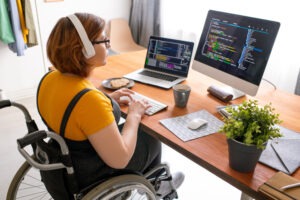 female freelance programmer with modern headphones sitting