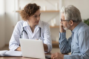 female doctor meeting with older patient