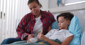 -black-child-with-mom Image alt text: injured black child with mom