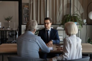 lawyer consulting with older couple