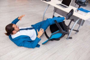 man falling away from office desk