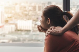 sad woman looking out of window