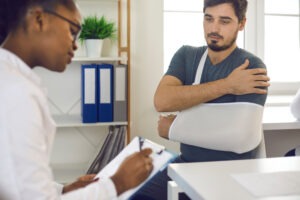 doctor talking to patient with arm cast