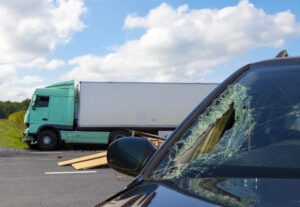 car with broken window after truck crash