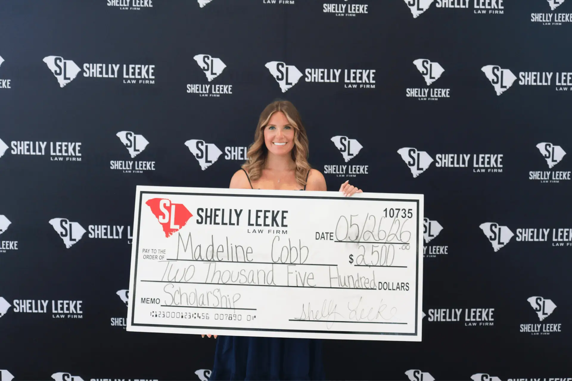 Scholarship Winner Poses with Large Check
